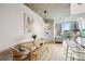 Open-concept dining area with modern table and seating, offering bright light and city skyline views at 210 N Church St # 2807, Charlotte, NC 28202