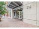The building's entrance features a modern canopy, glass doors, and a well-maintained brick walkway at 210 N Church St # 2807, Charlotte, NC 28202