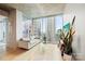 Bright living room with floor-to-ceiling windows offering a panoramic city view, and modern furnishings at 210 N Church St # 2807, Charlotte, NC 28202