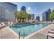 Rooftop pool with city views, surrounded by lounge chairs for relaxing and sunbathing at 210 N Church St # 2807, Charlotte, NC 28202