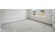 Light-filled bedroom with soft carpet and a view of the neighborhood at 21063 Running Creek Dr # 11, Locust, NC 28097