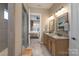 En-suite bathroom with double vanity sinks, walk-in shower, and tile floors at 215 Pintail Dr, Monroe, NC 28110