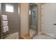 Modern bathroom with glass enclosed walk-in shower, stone floor, and tiled walls at 215 Pintail Dr, Monroe, NC 28110