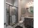 Modern bathroom featuring a glass-enclosed shower, sleek vanity, and tiled floors at 215 Pintail Dr, Monroe, NC 28110