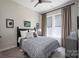 Comfortable bedroom with a queen-size bed, side tables, and lots of natural light at 215 Pintail Dr, Monroe, NC 28110