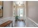 Bright foyer with white wainscoting, hardwood floors, and a view of the living area at 215 Pintail Dr, Monroe, NC 28110