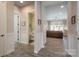 Hallway with hardwood floors leading to a living area and a powder room at 215 Pintail Dr, Monroe, NC 28110