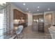 Open-concept kitchen with granite island, stainless appliances and wooden cabinets at 215 Pintail Dr, Monroe, NC 28110