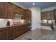 Modern kitchen with stainless steel appliances, granite countertops, and wooden cabinets at 215 Pintail Dr, Monroe, NC 28110