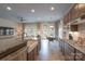 Open-concept kitchen with granite countertops, stainless steel appliances, and a view of the dining area at 215 Pintail Dr, Monroe, NC 28110