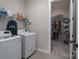 Functional laundry room with washer, dryer, shelving, and closet space at 215 Pintail Dr, Monroe, NC 28110