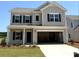 Two-story home features a front-entry garage, black shutters, landscaped yard and neutral-colored siding at 2199 Catawba Trace Dr, Catawba, NC 28609