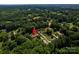 Aerial view showcases this home in a lush, wooded neighborhood with mature trees at 2209 Cardinal Loop, Stanley, NC 28164