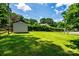 Expansive green backyard featuring a storage shed and a wooden fence, perfect for outdoor activities at 2209 Cardinal Loop, Stanley, NC 28164