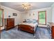Comfortable bedroom with plush carpeting, ceiling fan, and plenty of natural light at 2209 Cardinal Loop, Stanley, NC 28164