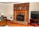 Close up of brick fireplace with wooden mantel in the living room of the house at 2209 Cardinal Loop, Stanley, NC 28164