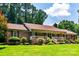 Charming brick home featuring a inviting front porch and meticulously landscaped front yard at 2209 Cardinal Loop, Stanley, NC 28164