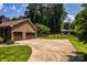Two-car garage with a wide driveway and a well-maintained lawn showcasing ample parking at 2209 Cardinal Loop, Stanley, NC 28164