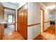 Hallway view with wood floors, closet, and doors leading to different rooms in the house at 2209 Cardinal Loop, Stanley, NC 28164