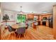 Bright kitchen with hardwood floors, a center island and a breakfast nook next to sliding glass doors at 2209 Cardinal Loop, Stanley, NC 28164