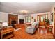 Inviting living room with hardwood floors, brick fireplace, and plenty of natural light at 2209 Cardinal Loop, Stanley, NC 28164