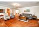 Open living room features hardwood floors, comfortable seating, and neutral wall color at 2209 Cardinal Loop, Stanley, NC 28164