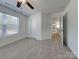 Bedroom featuring neutral carpet, a ceiling fan, a window, and a closet at 231 Brook Se Ave, Concord, NC 28025