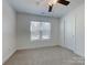 Bedroom with a ceiling fan, neutral carpet, and a window providing natural light at 231 Brook Se Ave, Concord, NC 28025