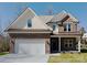 Charming two-story home with a brick and siding exterior, attached two car garage and well manicured front yard at 231 Brook Se Ave, Concord, NC 28025