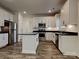 Modern kitchen featuring stainless steel appliances, white cabinetry, an island and dark countertops at 231 Brook Se Ave, Concord, NC 28025