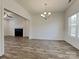 Open concept dining room and living room with modern chandelier, wood laminate floors and lots of natural light at 231 Brook Se Ave, Concord, NC 28025