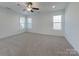 Bright main bedroom with plush carpet, a ceiling fan and double windows providing ample natural light at 231 Brook Se Ave, Concord, NC 28025