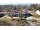 This aerial shot displays a one story home in the winter with blue shutters and trees at 2316 Woodfield Cir, Gastonia, NC 28056