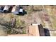 The aerial shot shows sheds, garden beds, and the home's brown roof in the backyard of this property at 2316 Woodfield Cir, Gastonia, NC 28056