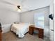 Bedroom with a neutral palette features wood floors, a ceiling fan, and a desk at 2316 Woodfield Cir, Gastonia, NC 28056