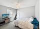 Relaxing bedroom offers a ceiling fan, a tv, and neutral carpet at 2316 Woodfield Cir, Gastonia, NC 28056
