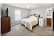 Cozy bedroom features a queen bed, neutral carpet and ceiling fan at 2316 Woodfield Cir, Gastonia, NC 28056