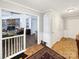 Open hallway leading to a living area, featuring hardwood floors and white trim at 2316 Woodfield Cir, Gastonia, NC 28056