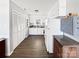 Bright kitchen with white cabinetry, laminate countertops, and wood floors at 2316 Woodfield Cir, Gastonia, NC 28056