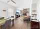 Open living room with brick fireplace, ceiling fan, and wood floors at 2316 Woodfield Cir, Gastonia, NC 28056