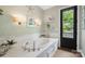 Luxurious soaking tub with white marble tile and views to the outside, adding style to the bathroom at 2354 Valelake Rd, York, SC 29745