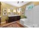 Bright bathroom with a glass-enclosed shower, double vanity, and framed artwork on the walls at 2354 Valelake Rd, York, SC 29745