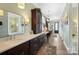 Luxurious bathroom with a long vanity, designer mirrors, and hallway access at 2354 Valelake Rd, York, SC 29745