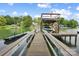 Private boat dock featuring a boat lift and upper level with American flag flying above at 2354 Valelake Rd, York, SC 29745