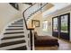 Grand entryway features a curved staircase and elegant furnishings, creating a welcoming ambiance at 2354 Valelake Rd, York, SC 29745