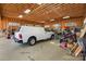 Spacious garage with exposed beam ceiling used for vehicle and general storage at 2354 Valelake Rd, York, SC 29745
