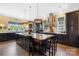 Spacious kitchen featuring dark cabinets, large center island, stainless steel appliances and unique light fixtures at 2354 Valelake Rd, York, SC 29745