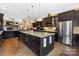 Open kitchen featuring an island with granite counters, stainless steel appliances, and adjacent living area at 2354 Valelake Rd, York, SC 29745