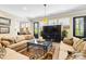 Cozy living room with plush sofas, a glass coffee table, and abundant natural light from multiple windows at 2354 Valelake Rd, York, SC 29745