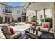 Covered patio with comfortable seating, offering views of the courtyard, pool, and rear facade of the home at 2354 Valelake Rd, York, SC 29745